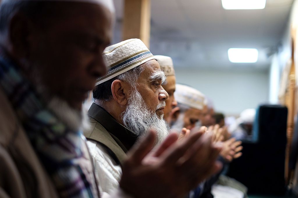 muslim men pray in a mosque