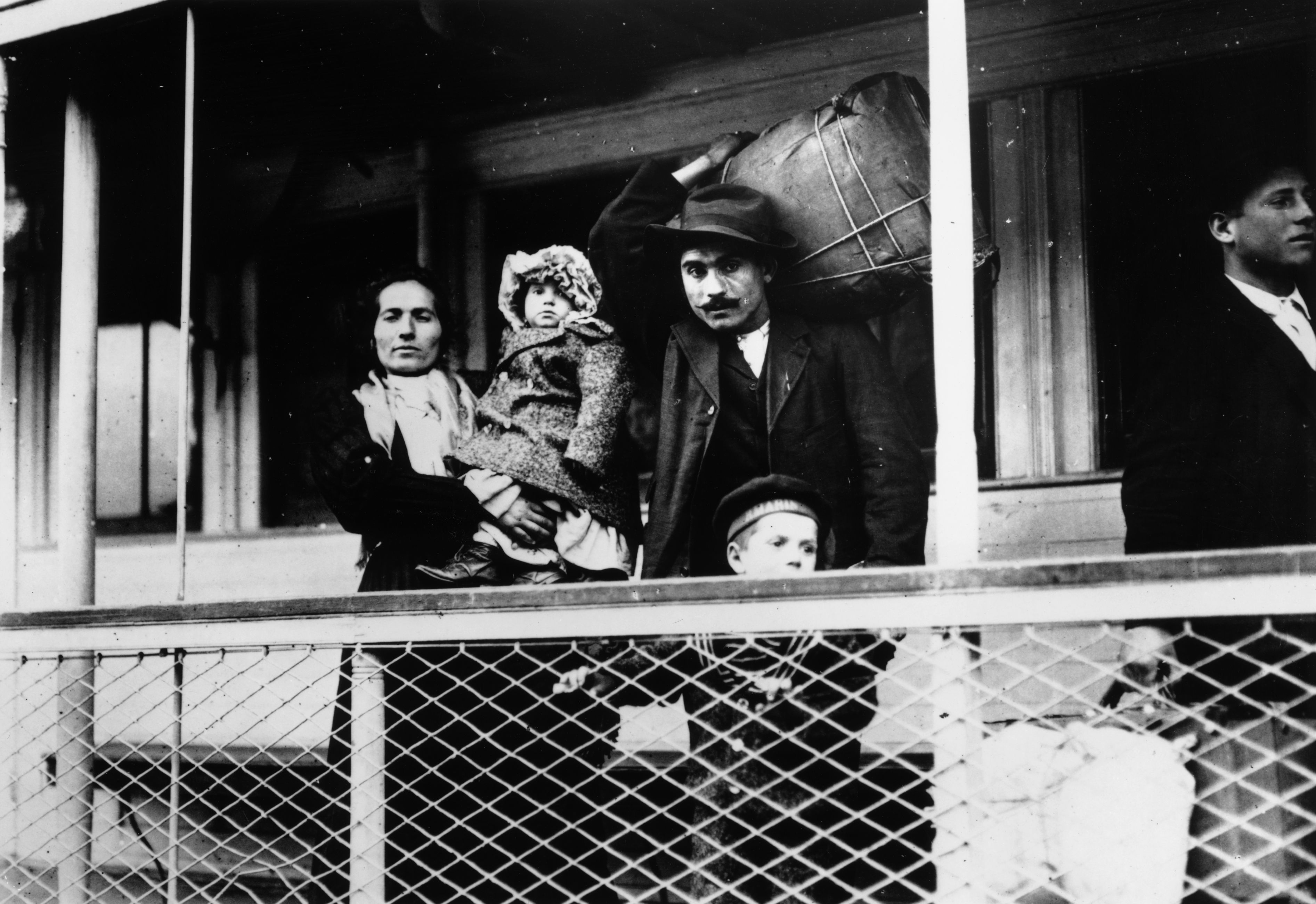 Italian immigrants on board a ferry from the docks to Ellis Island, New York
