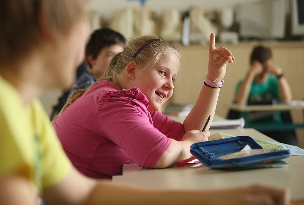 a student raises her hand