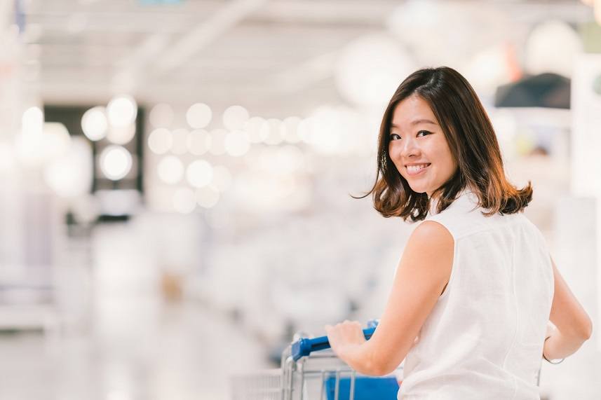 Woman smiling with shopping cart