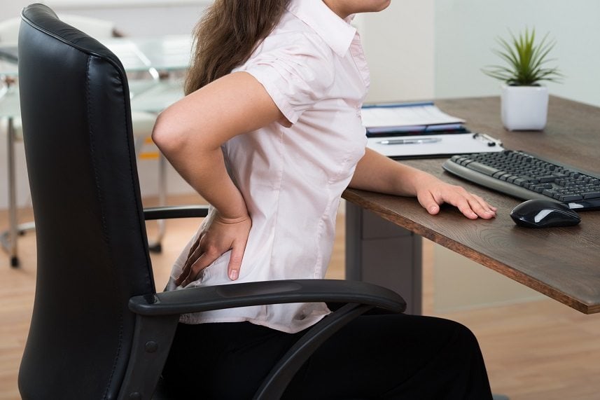 Young Businesswoman On Chair Having Backpain