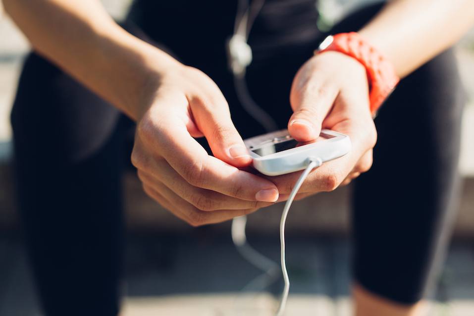 Woman setting the music playlist Woman setting the music playlist