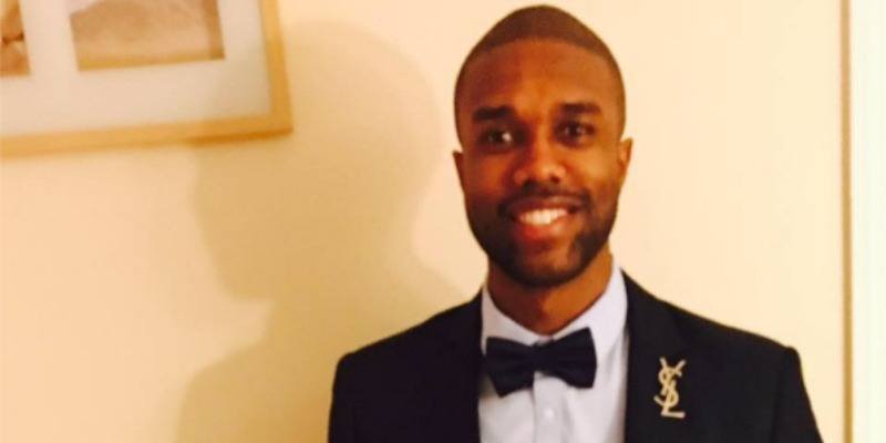 Demario Jackson in a suit and tie.