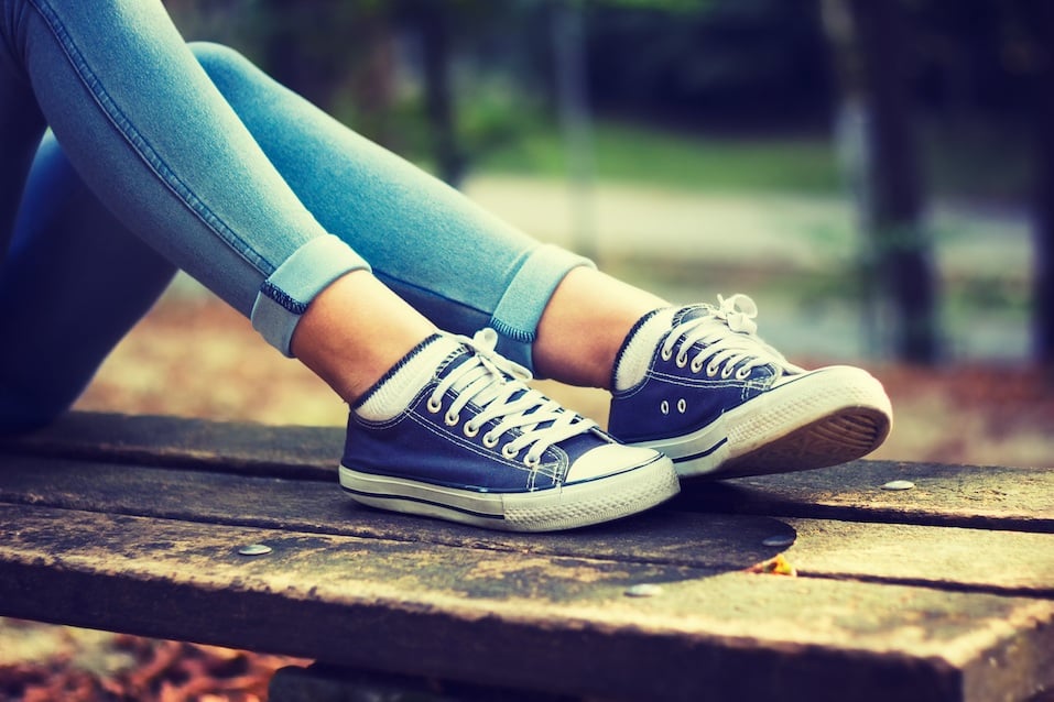 Young woman in blue sneakers