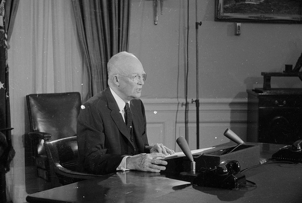 Dwight D. Eisenhower sitting at his desk