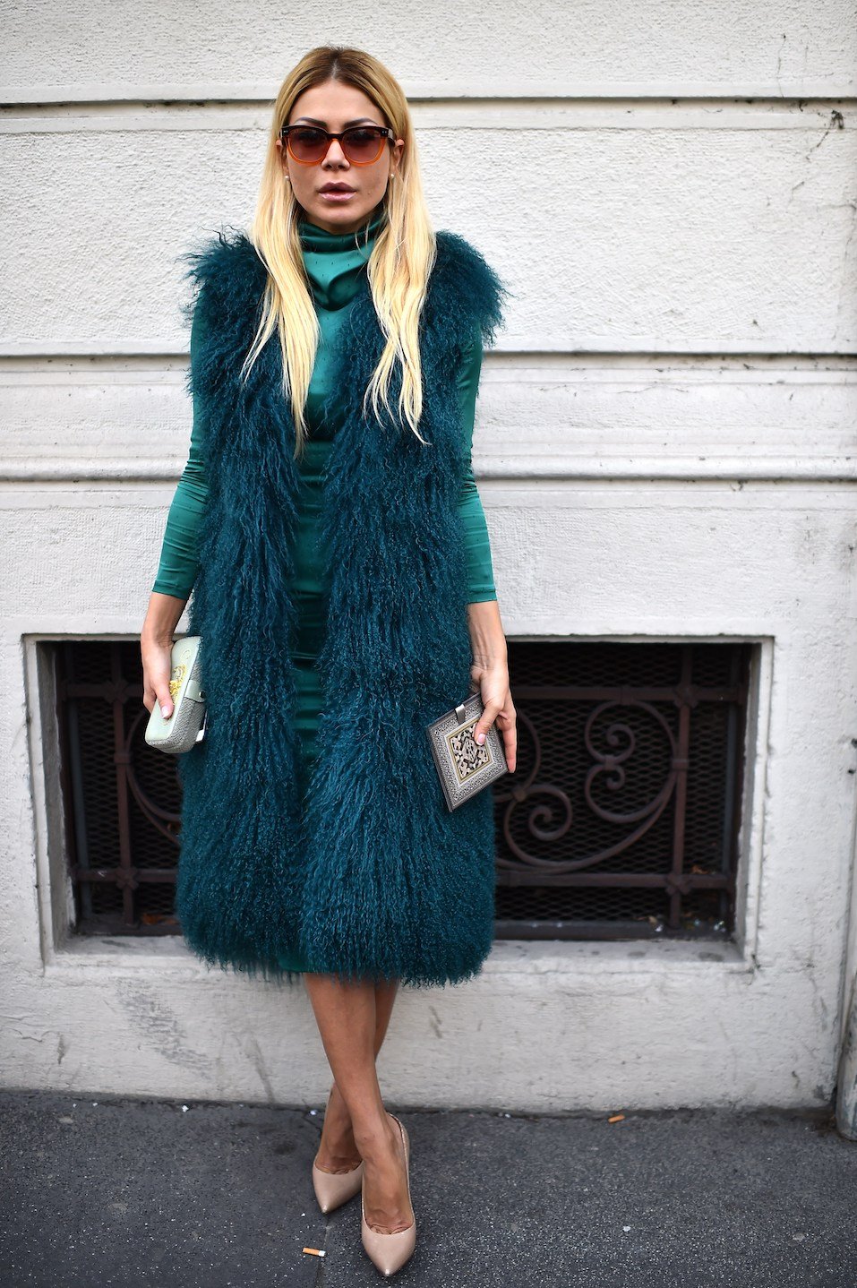 A woman poses in the street before the Etro show