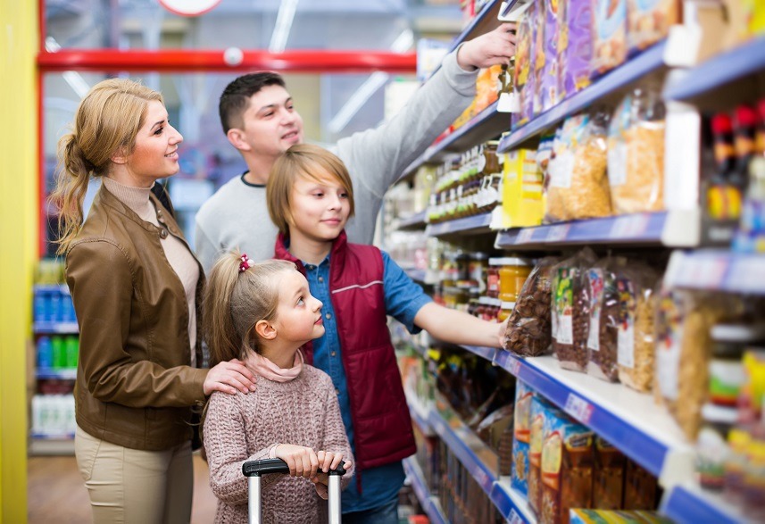 Family with children standing in supermarket
