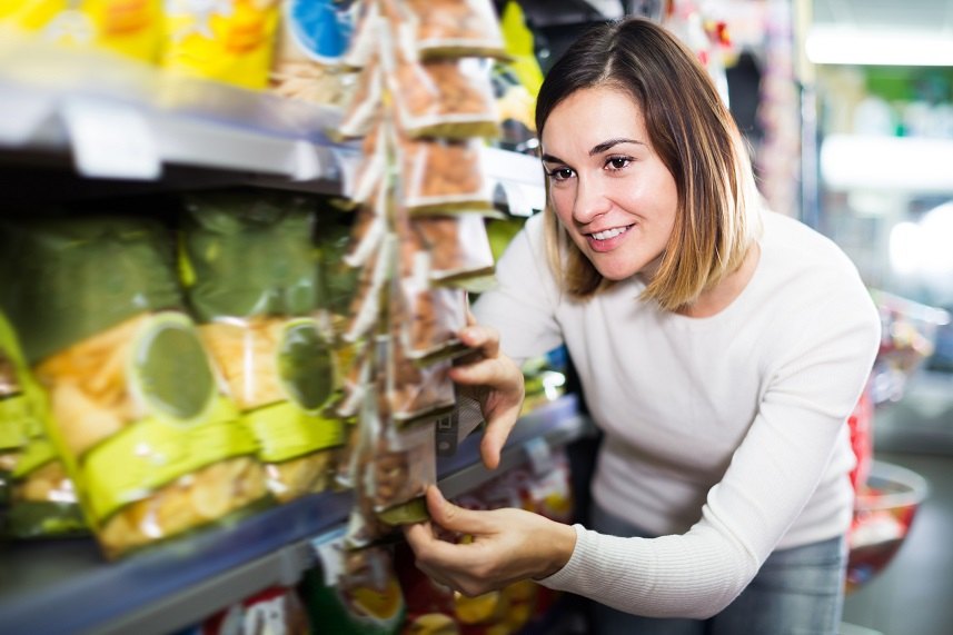 Female shopper searching for snacks
