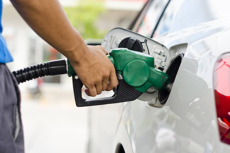 person filling up car with gas