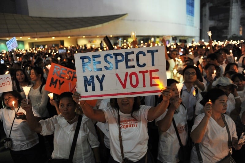 Pro-election democracy activists take part in a candlelight vigil backing democratic government in Bangkok.