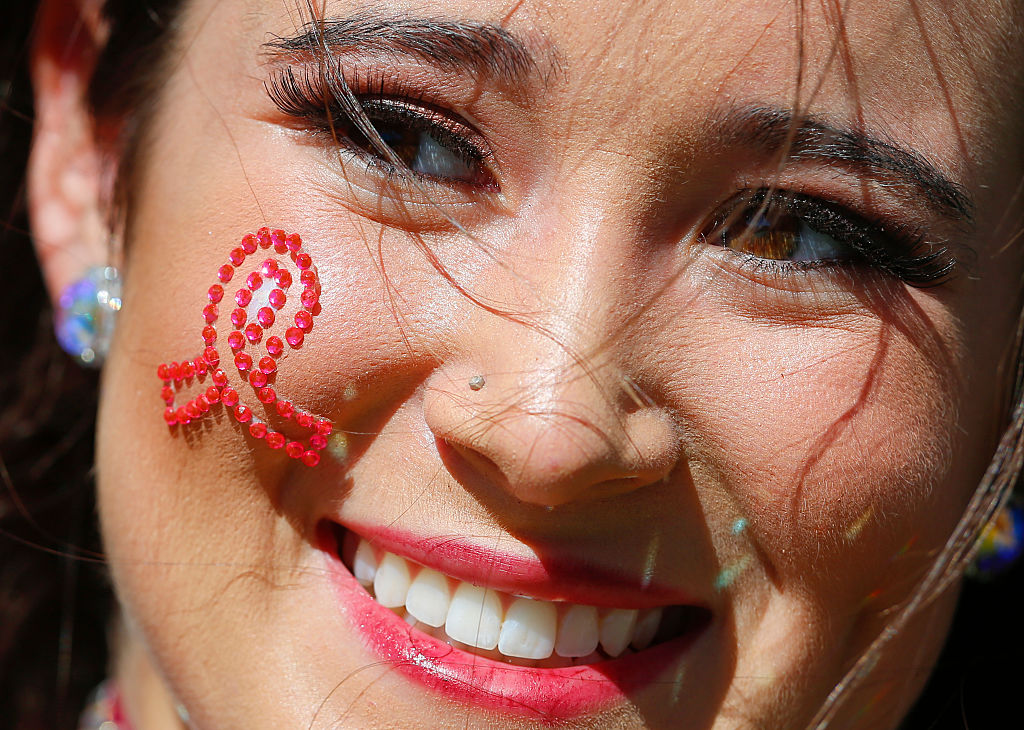 A Mississippi State Bulldogs cheerleader wears a Brest Cancer ribbon
