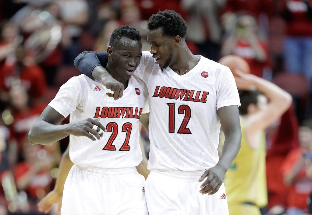 Deng Adel #22 and Mangok Mathiang #12 of the Louisville Cardinals celebrate a big win.