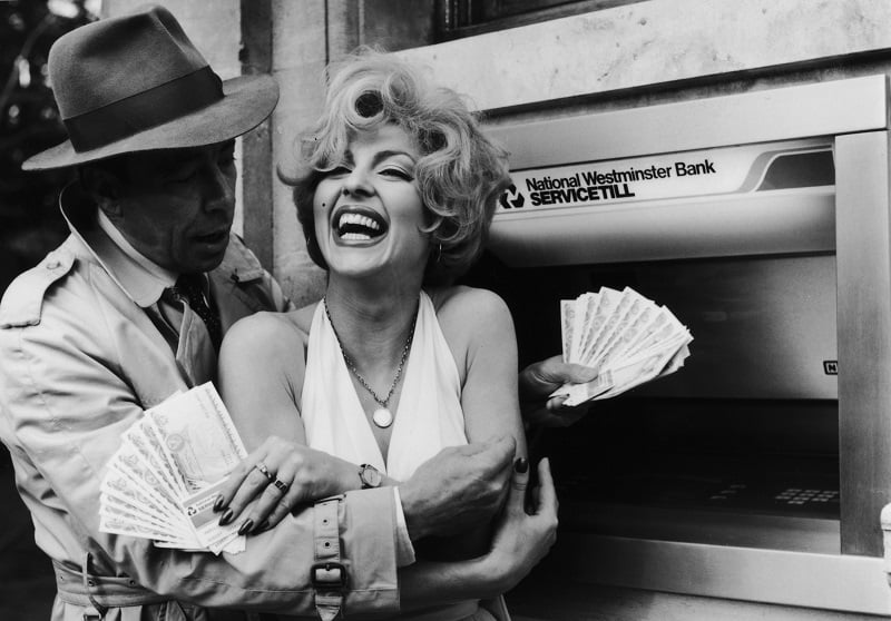 Celebrity lookalikes embrace holding money