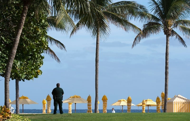 A security agent stands guard near the beach