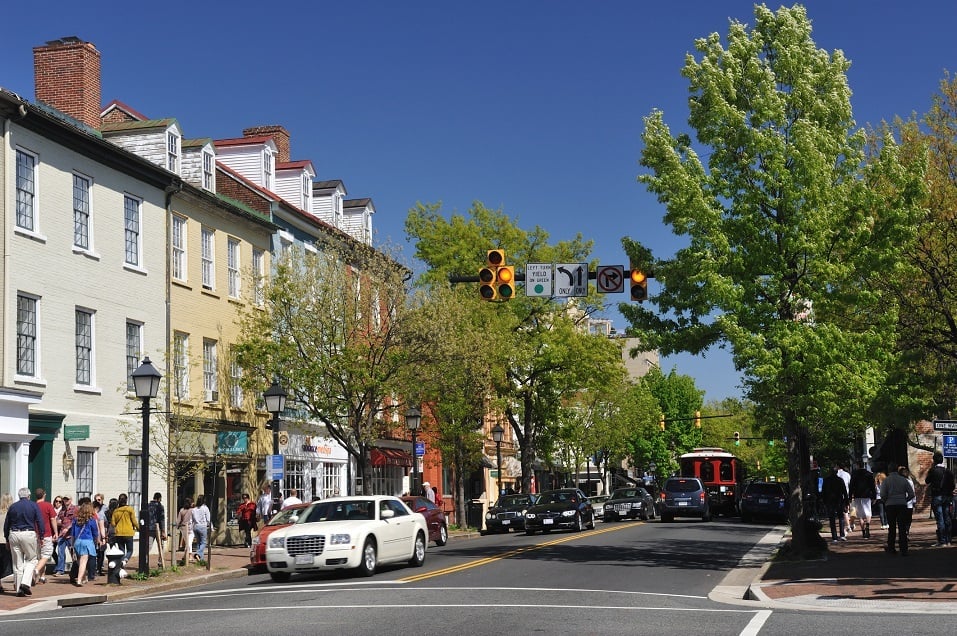 Traffic on KIng Street with people walking on sidewalk along in Old Town Alexandria