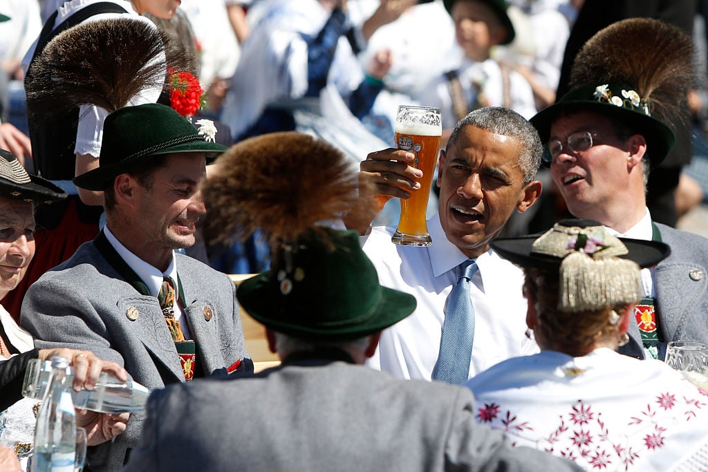 Barack Obama enjoys a beer.