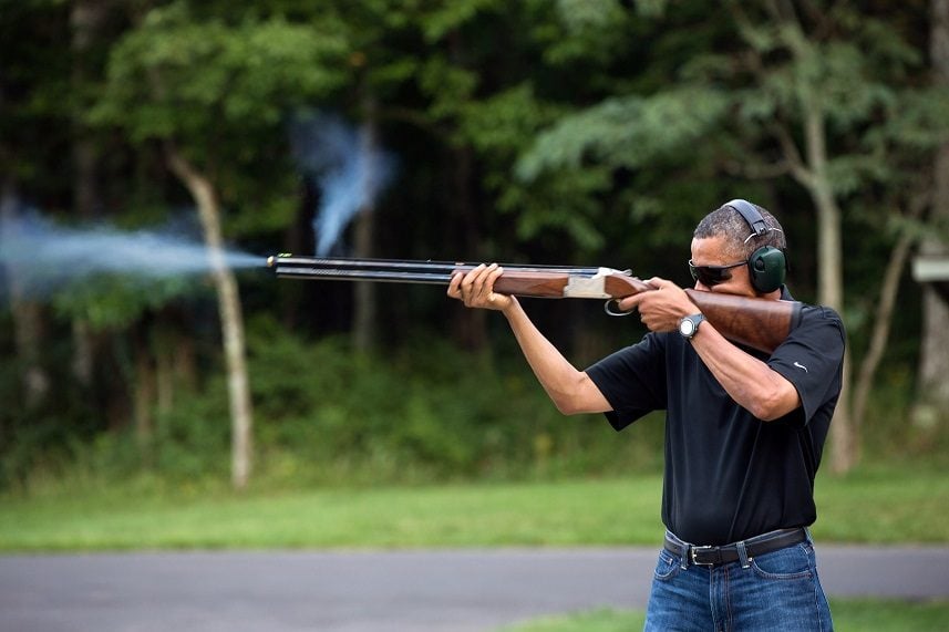 Barack Obama shoots clay targets with a shotgun on the range at Camp David, Maryland