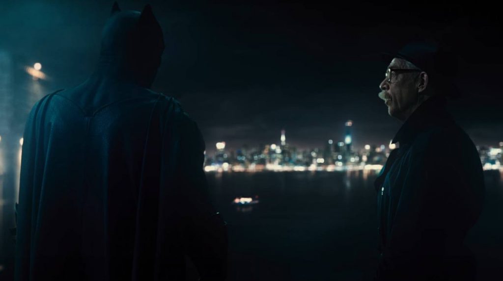 Commissioner Gordon and Batman have a conversation on a rooftop