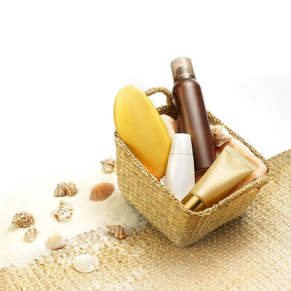 Suntan creams in a beach basket