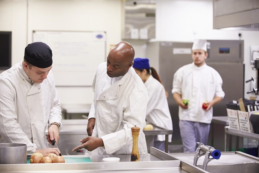 Teacher training students In catering cutting onions