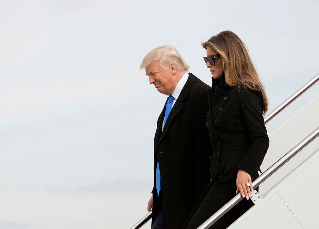 Donald and Melania Trump exit an airplane.