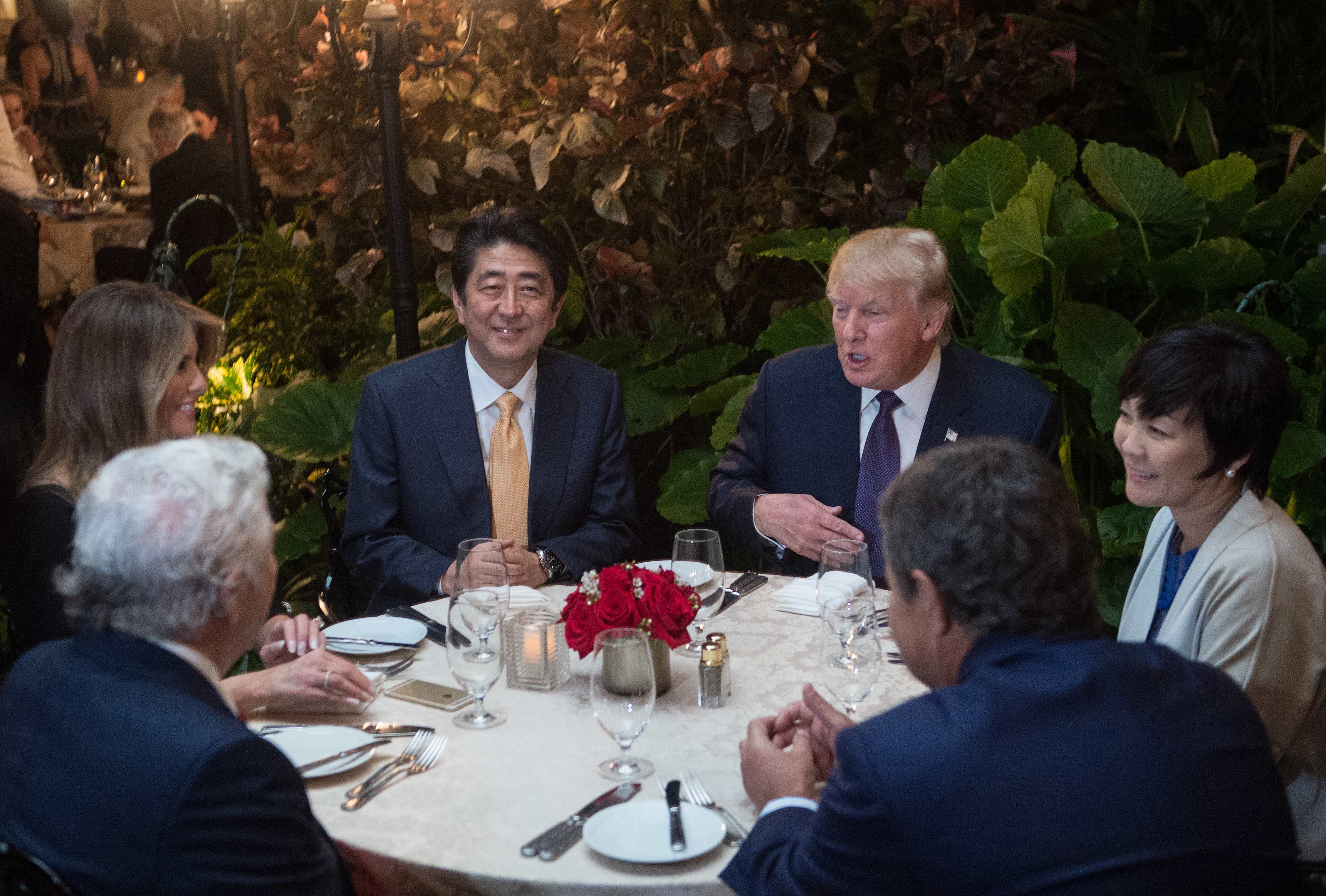 President Donald Trump and other influential people sit down for dinner.