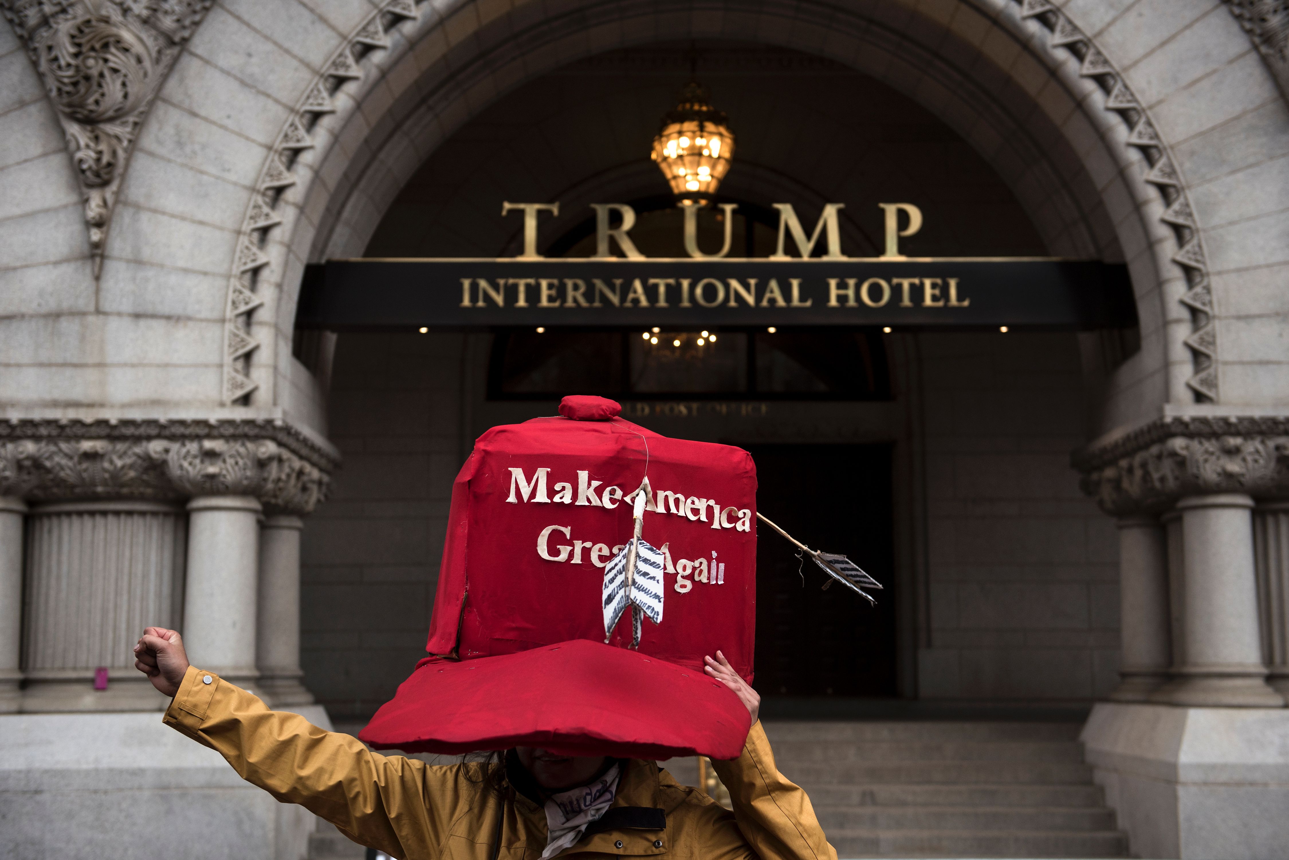 An activist stands in front of Trump International Hotel, one of the Donald Trump hotels
