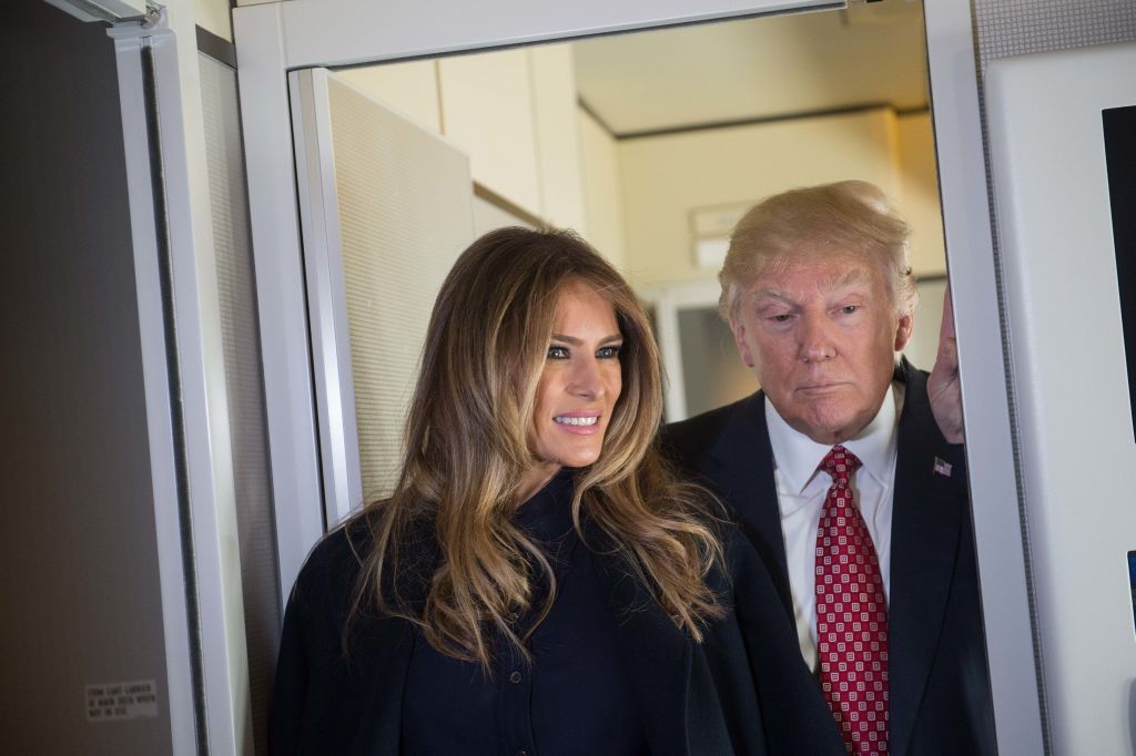 US President Donald Trump speaks to the press with First Lady Melania Trump