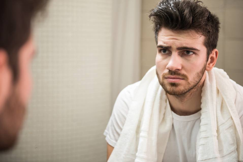 Man is looking at the mirror