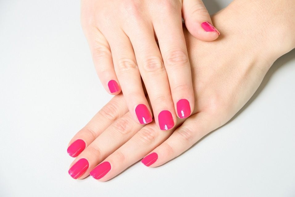 High Angle Close Up of Woman Wearing Bright Pink Polish