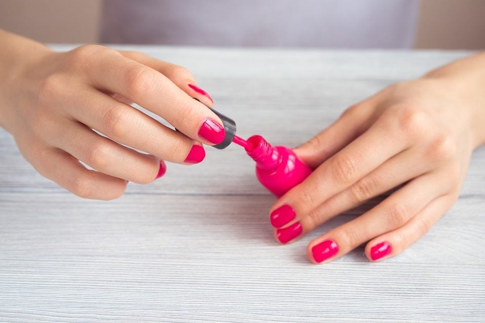 Women's hands with a red manicure