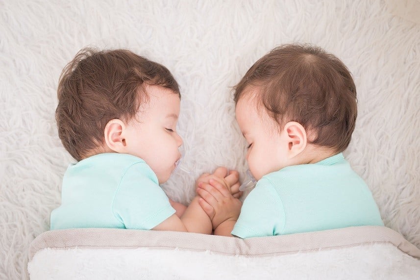 Baby twins sleeping with pacifier