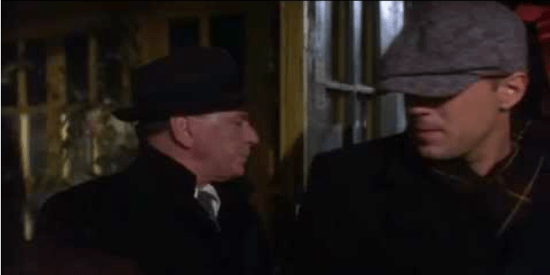 Bruce Willis in The First Deadly Sin in a coat and hat.