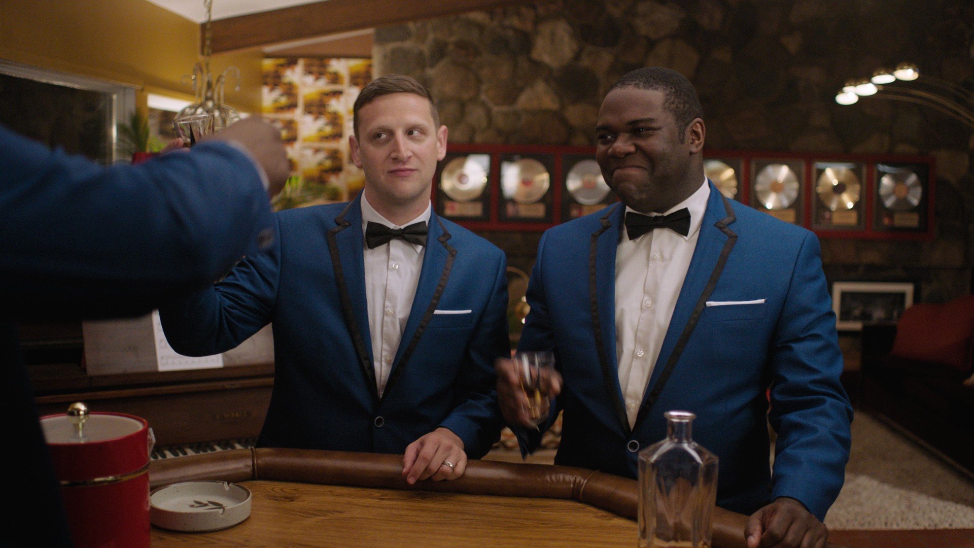 Sam Richardson and Tim Robinson raise a toast in a scene from Detroiters