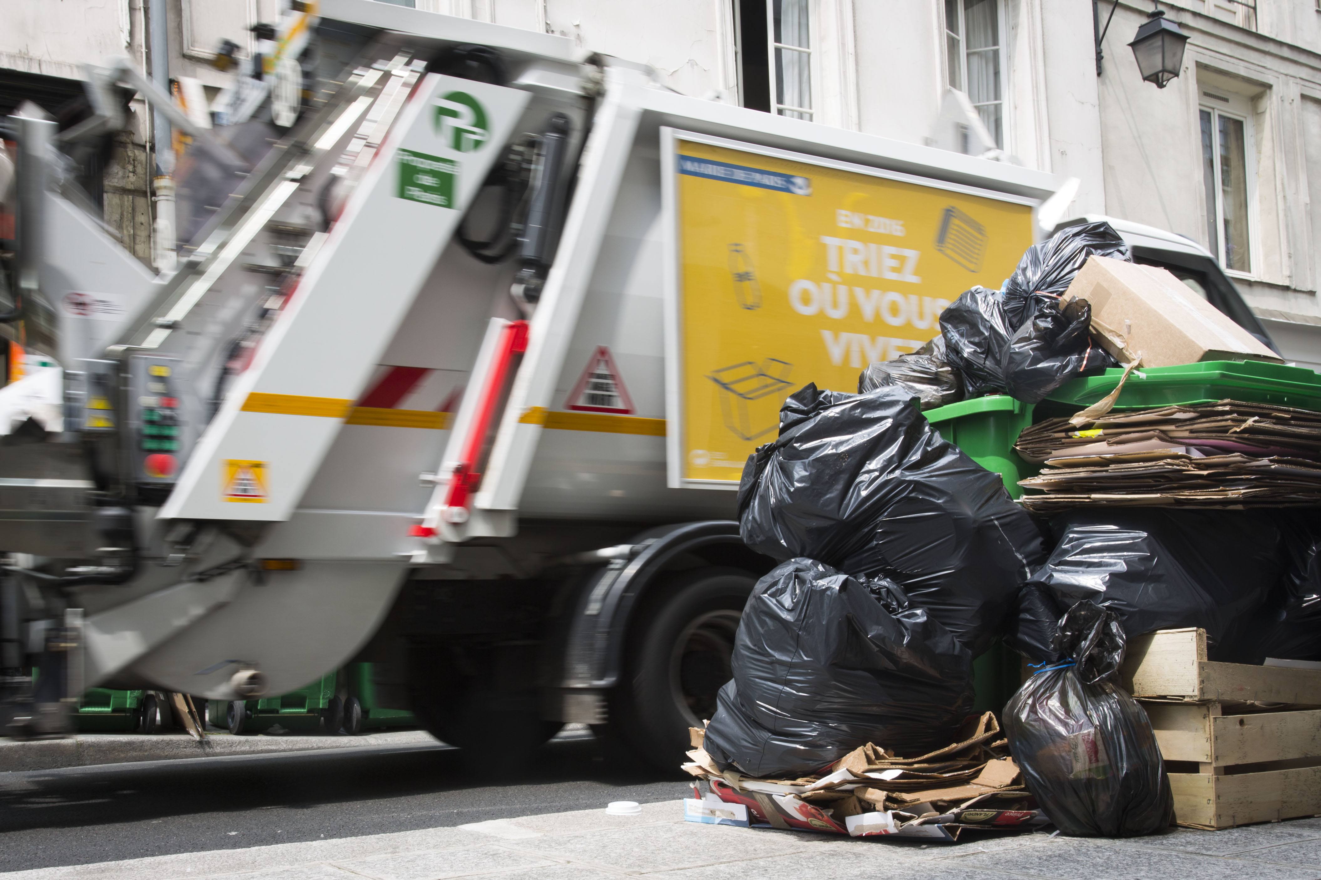 A French garbage truck collects refuse