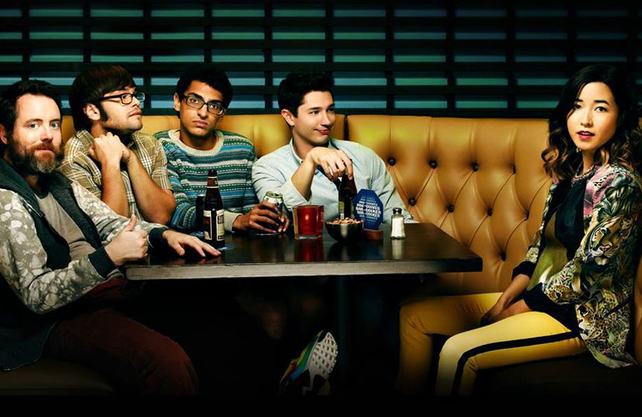 The cast of Amazon comedy Betas sitting in a booth