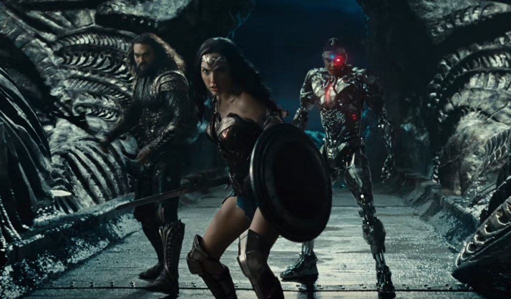 Wonder Woman leads Aquaman and Cyborg in battle in a scene from Justice League