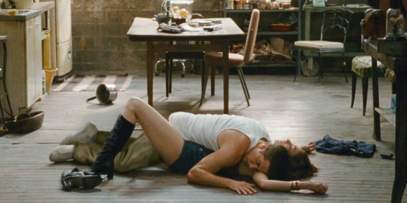 Jamie lying on top of Maggie on the floor in Love & Other Drugs