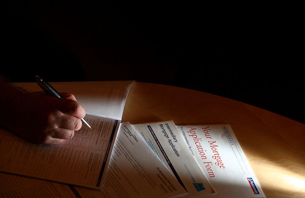 A man looks over financial forms