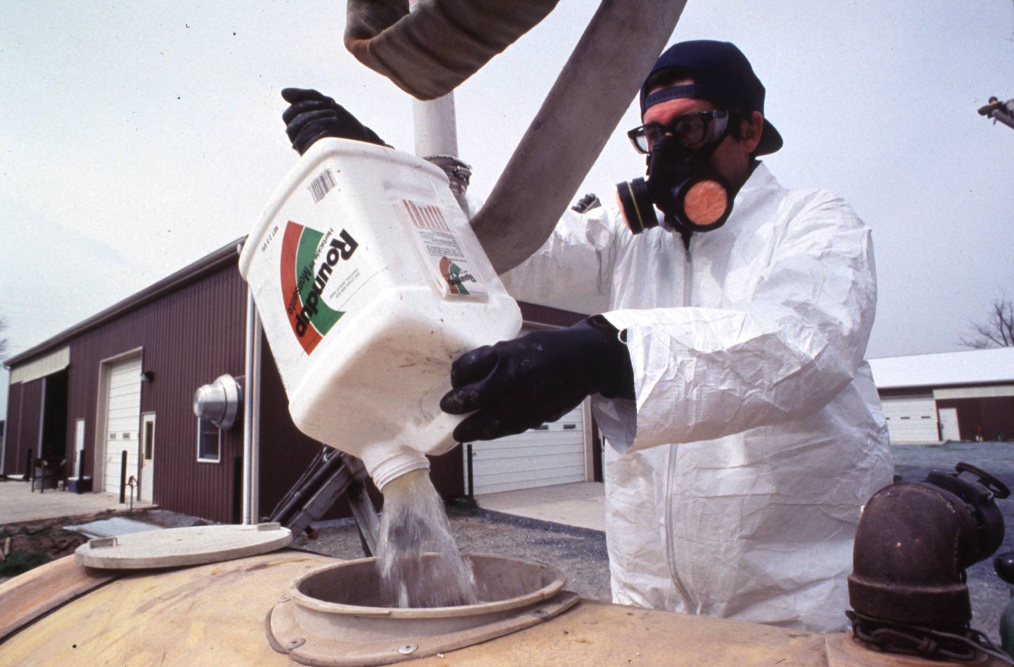 A farm worker handles a common pesticide