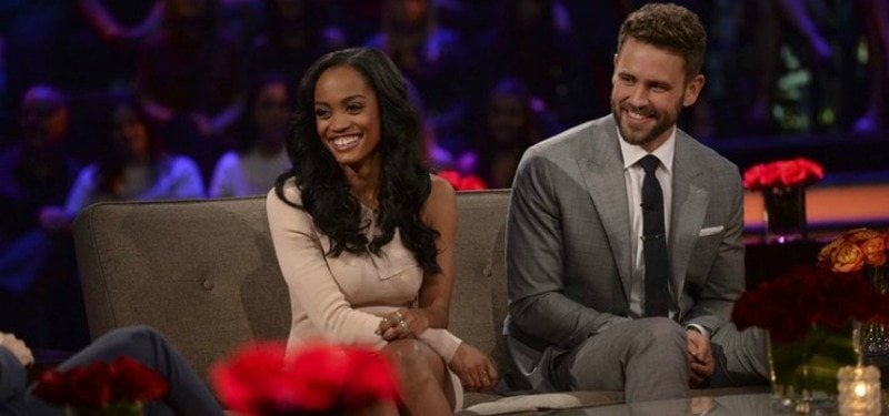 Rachel Lindsay and Nick Viall sitting next to each other and smiling on Women Tell All