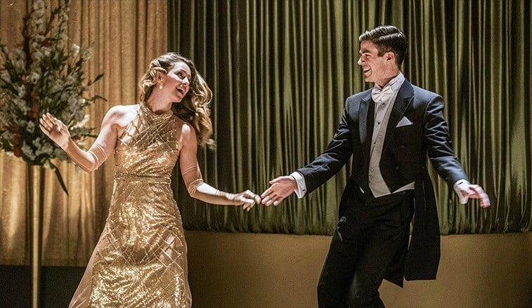 A woman and a man dancing in fancy attire.