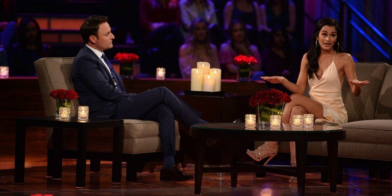 Taylor talking to the crowd as Chris Harrison listens on Women Tell All