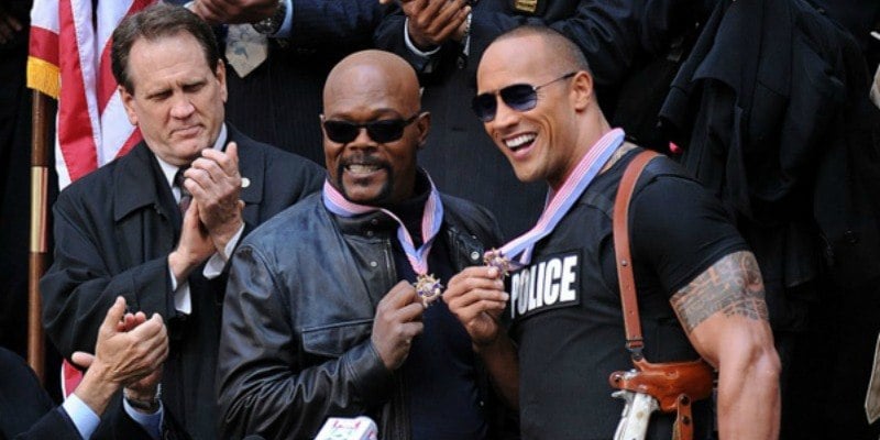 Dwayne Johnson and Samuel L. Jackson are posing together with medals for The Other Guys.