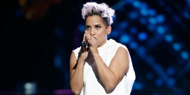 Vicci Martinez is holding the microphone very closely to her face as she sings. Vicci Martinez is holding the microphone very closely to her face as she sings.