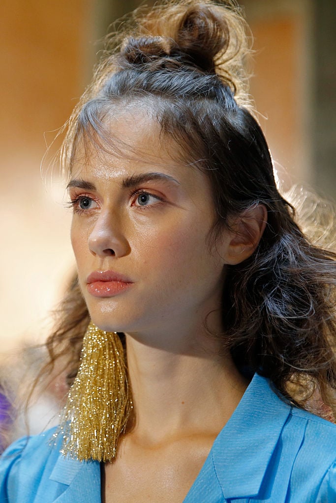 A model, earring detail, seen backstage