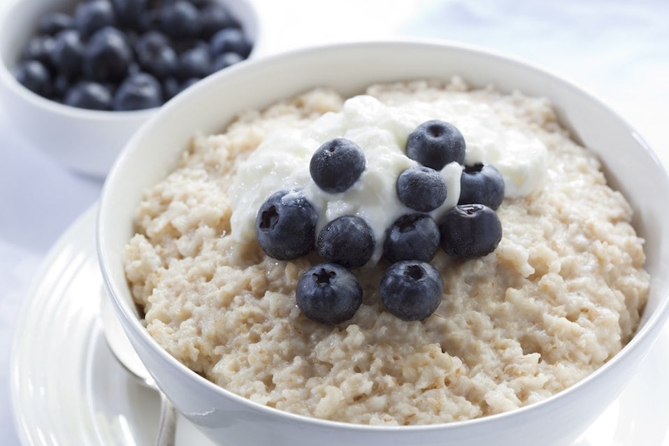 Bowl of oatmeal porridge, topped with fresh blueberries and yogurt Bowl of oatmeal porridge, topped with fresh blueberries and yogurt
