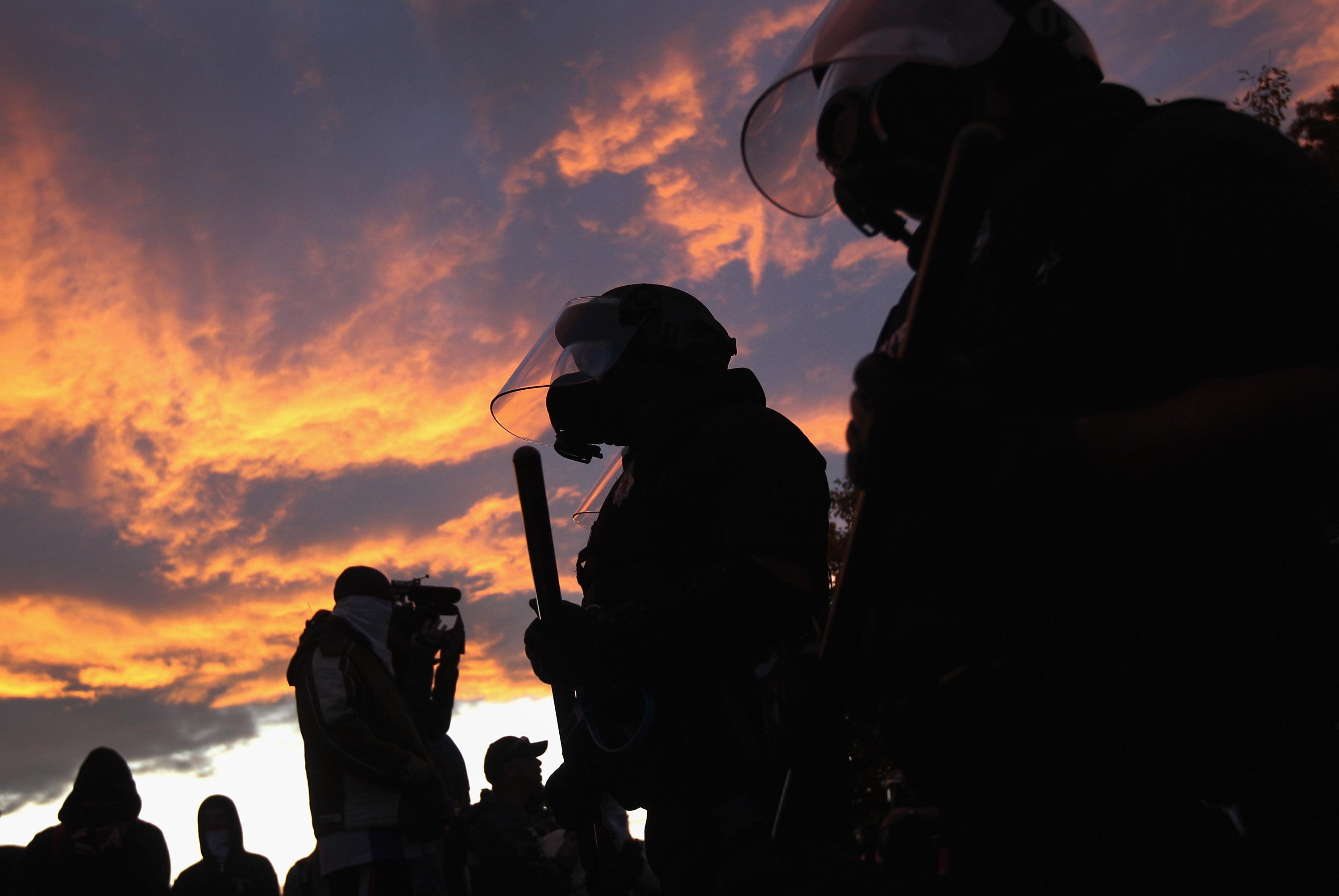Riot police face off with demonstrators at the "Occupy Denver" camp
