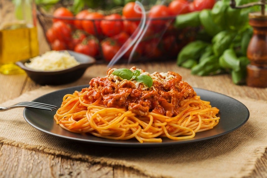 spaghetti served on a black plate