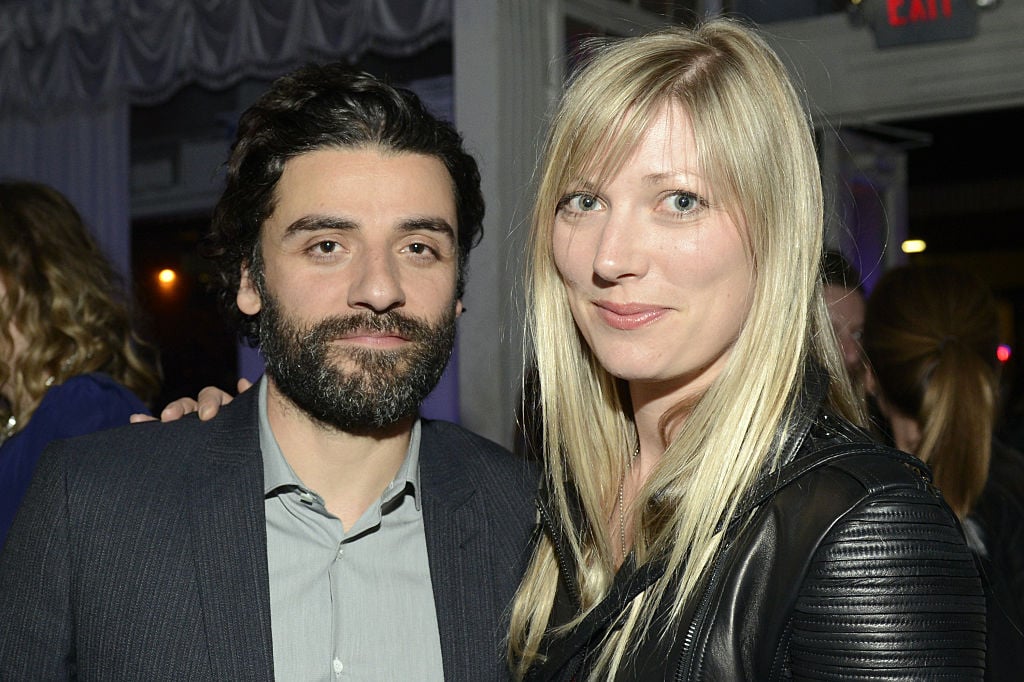 A bearded Oscar Isaac smiles alongside Elvira Lind